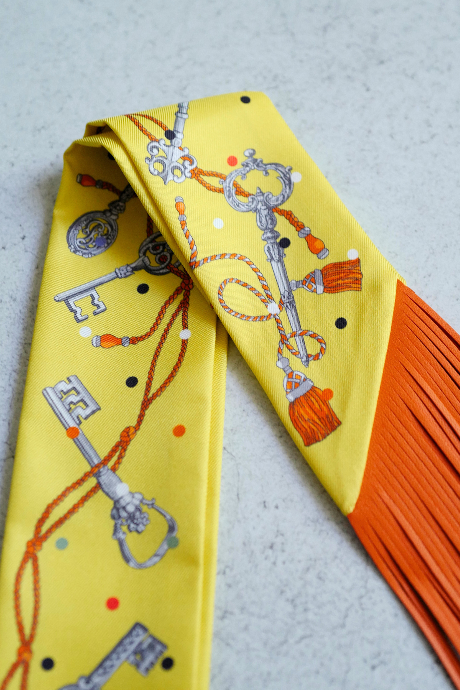 Hermès Twilly Les Cles a Pois Leather Fringes Jaune/Argent /Orange vif Silk