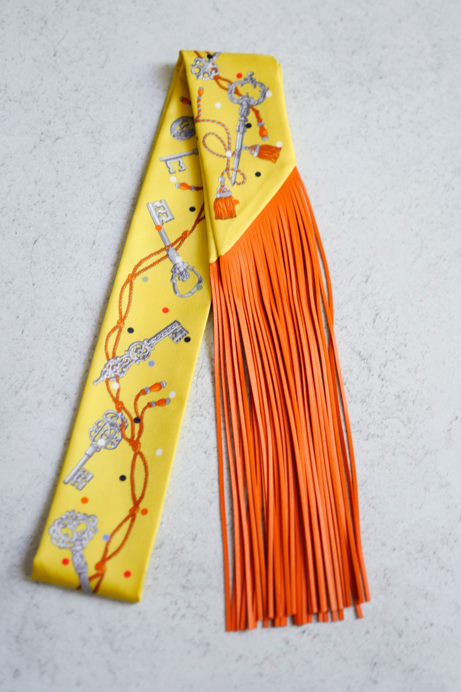 Hermès Twilly Les Cles a Pois Leather Fringes Jaune/Argent /Orange vif Silk